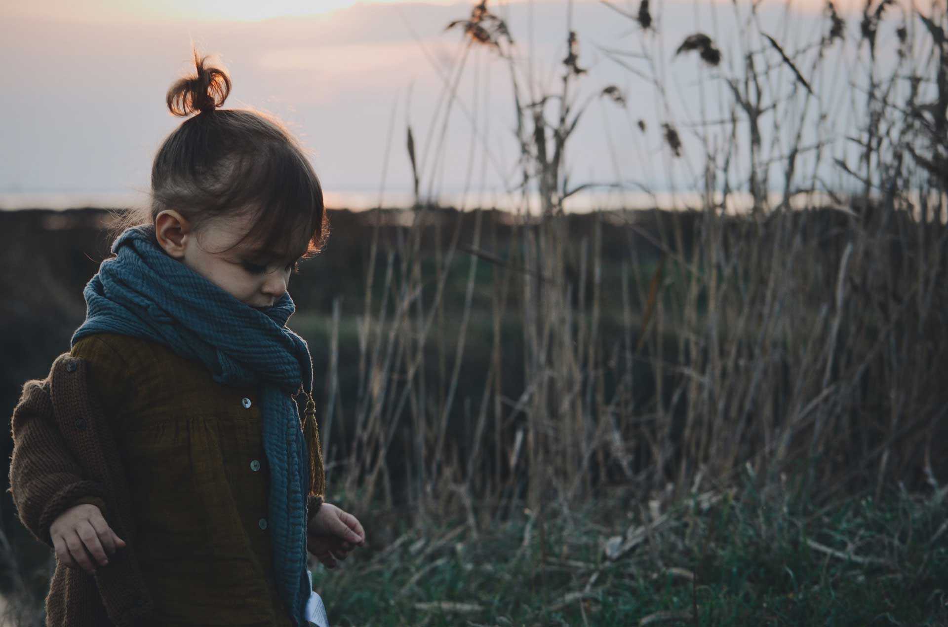 young girl in warm sweater and scarf outside