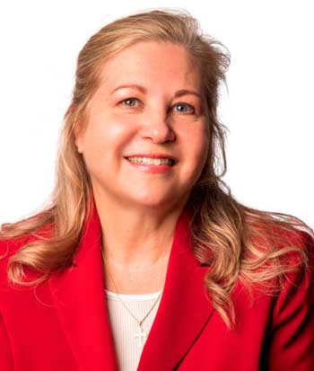 smiling woman with blonde hair and red suit